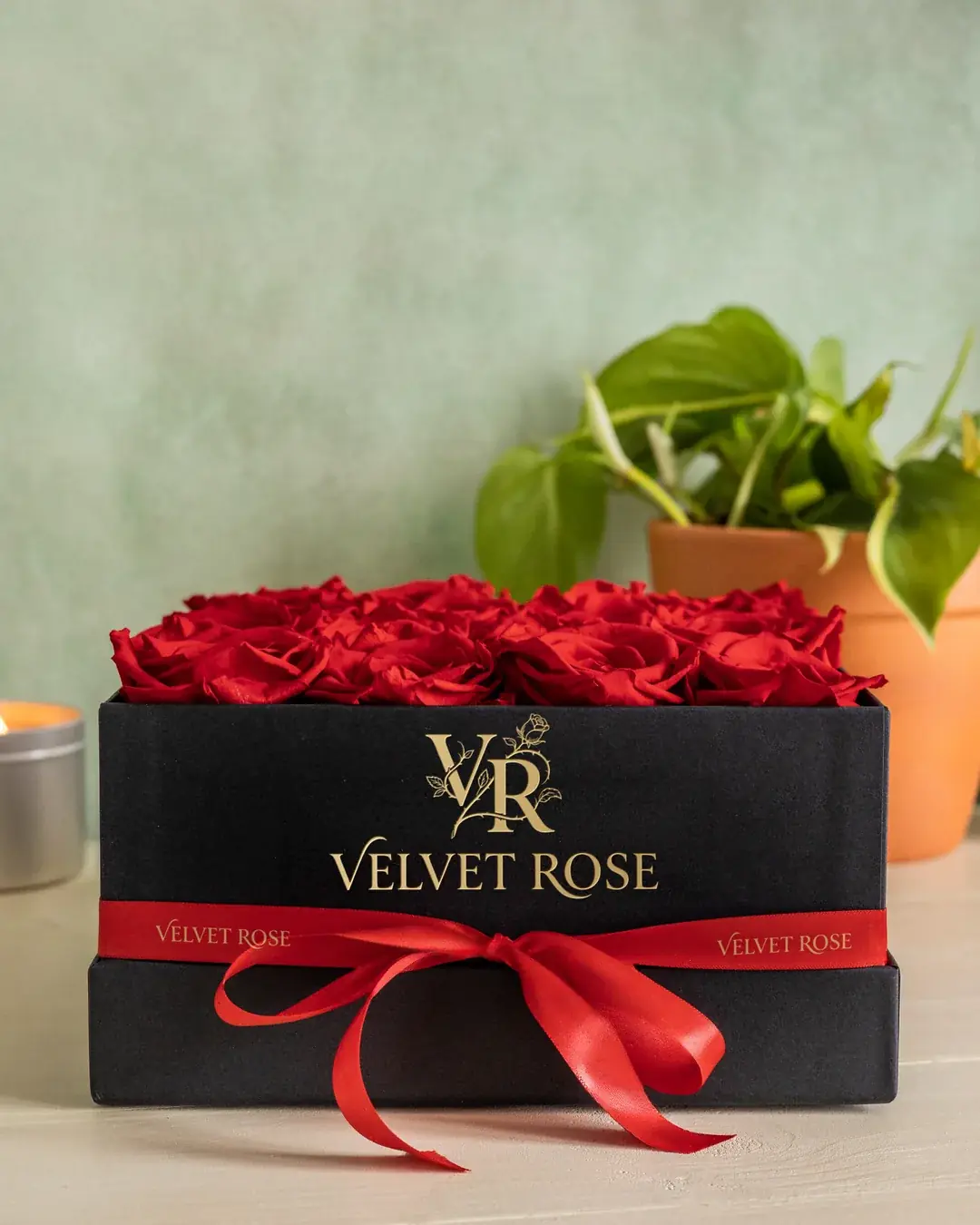 The Signature Box: sixteen red preserved roses in a black box with red ribbon