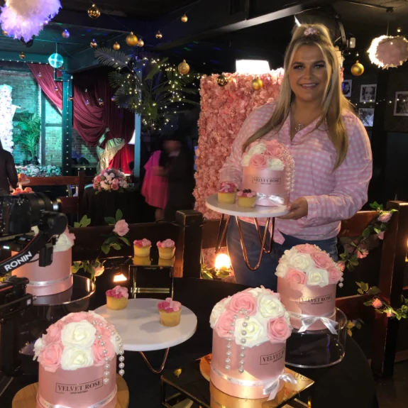 A guest holding a Velvet Rose centrepiece at a TOWIE evening event