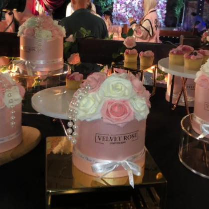Velvet Rose centrepieces on lit tables at a TOWIE evening event